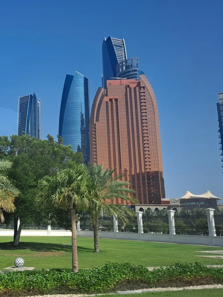 Abu Dhabi towers seen through palm trees from the grounds of Qasr Al Watan