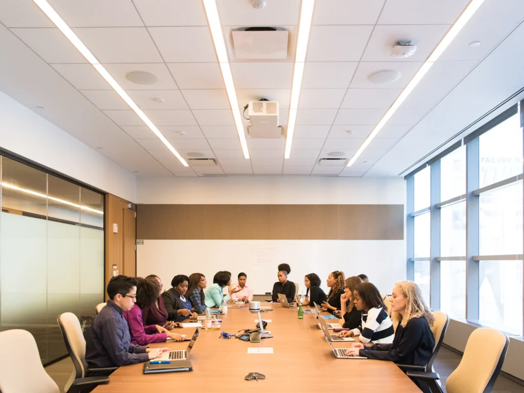 A board meeting around a long conference table