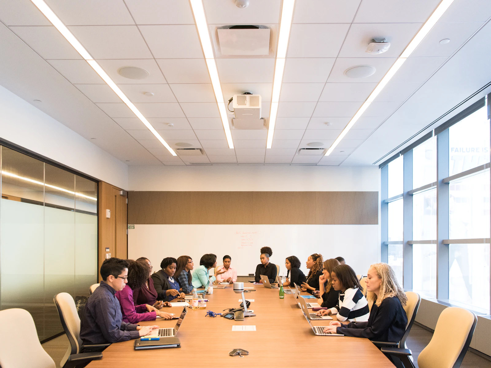A board meeting around a long conference table