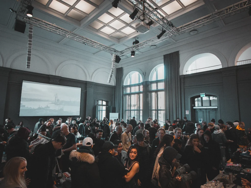 A crowded business event in a large hall