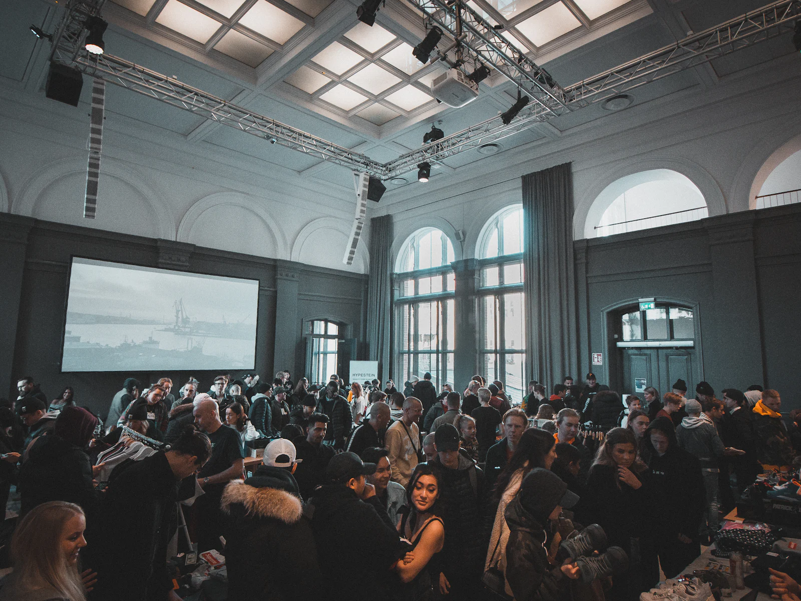 A crowded business event in a large hall