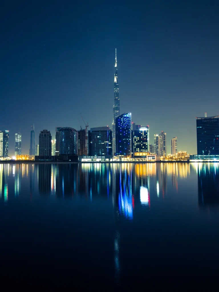 The Dubai skyline and the Burj Khalifa reflected in the water at dusk