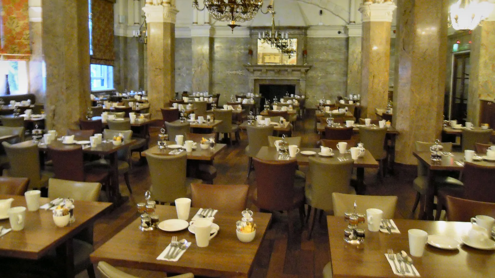 Tables laid for service in a hotel restaurant dining room