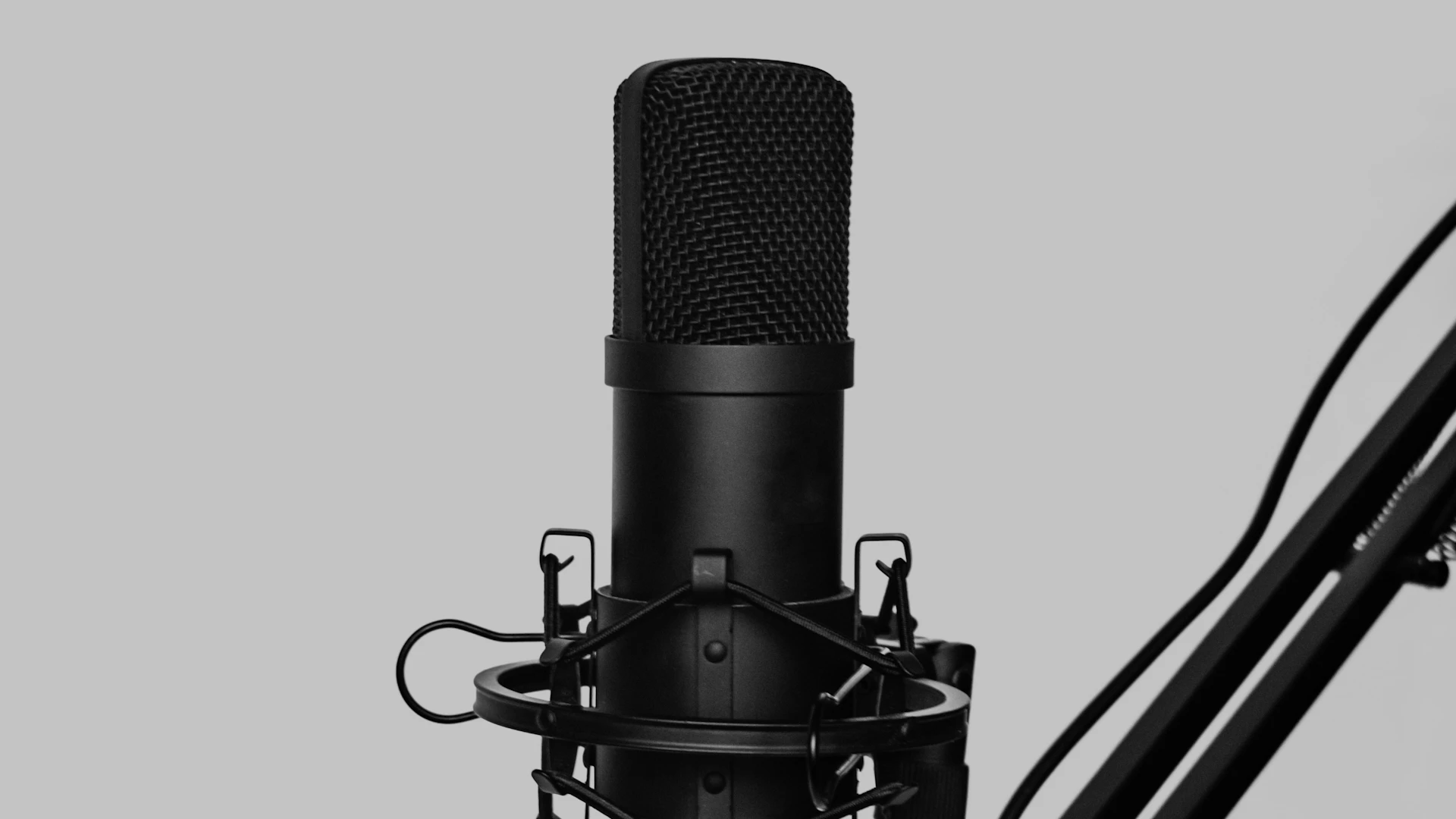 A studio microphone on a boom arm