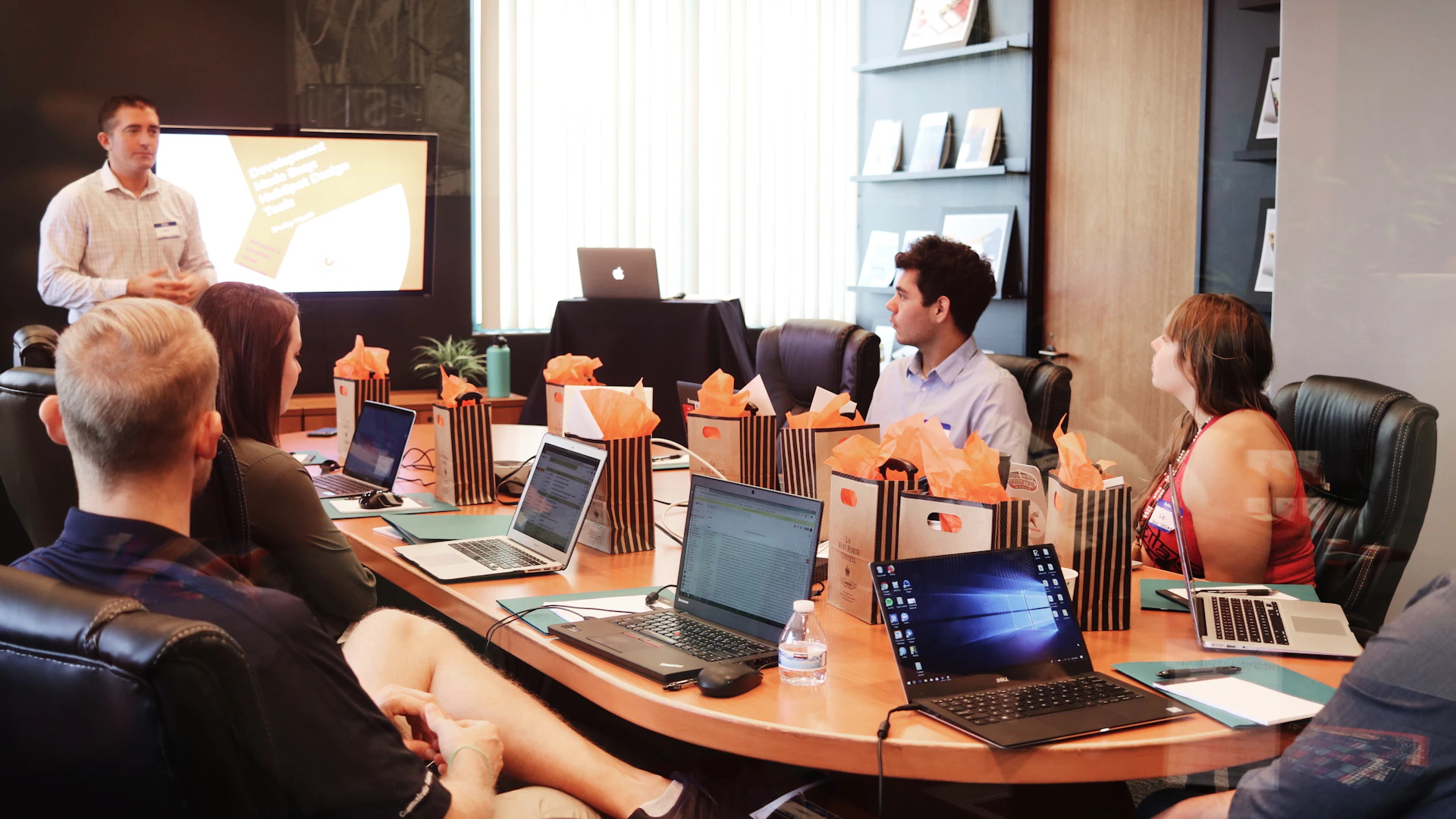 A presenter leading a team meeting in a boardroom